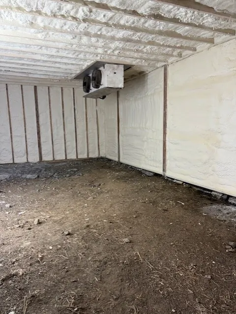 Corner of an encapsulated crawl space with closed-cell spray foam on the walls