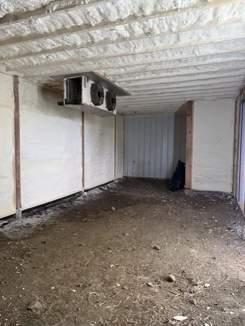 Crawl space with walls and ceiling fully sprayed with closed-cell spray foam insulation